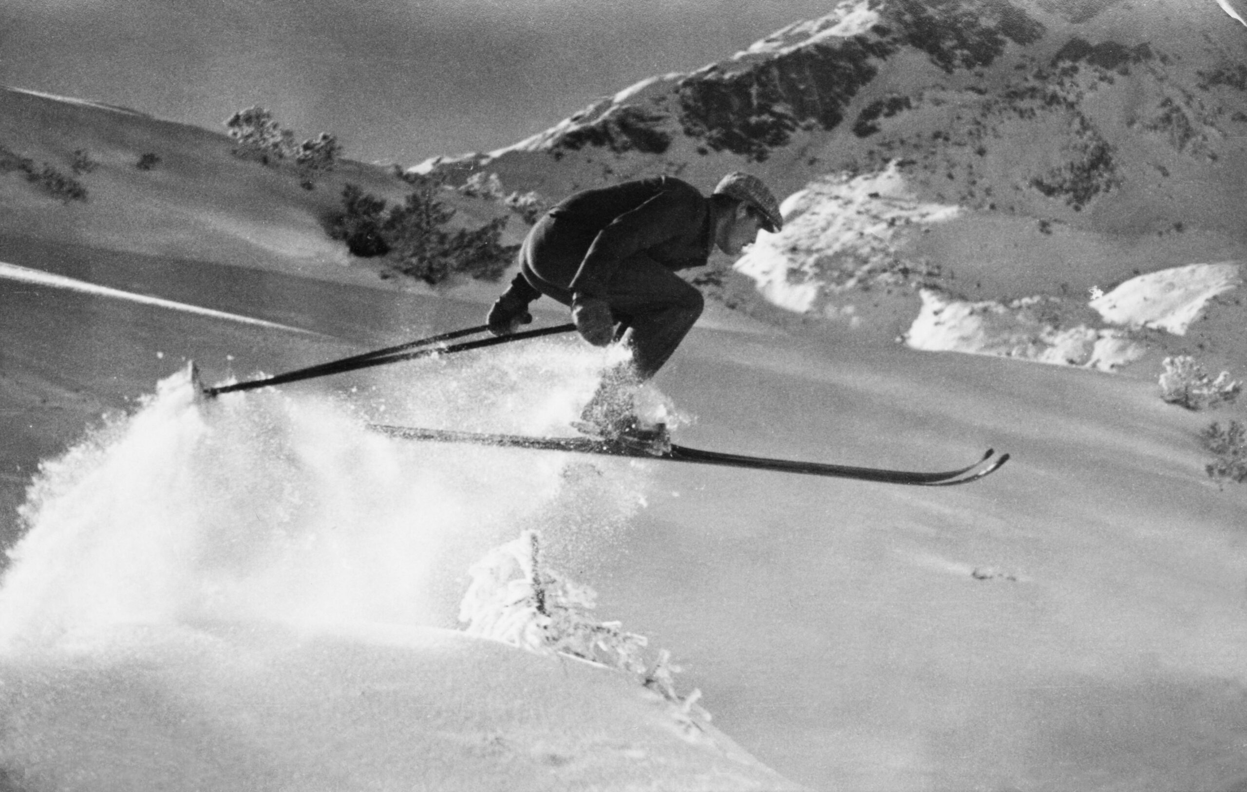 Historic photograph of Richard Falch skiing through deep powder snow in St. Anton am Arlberg